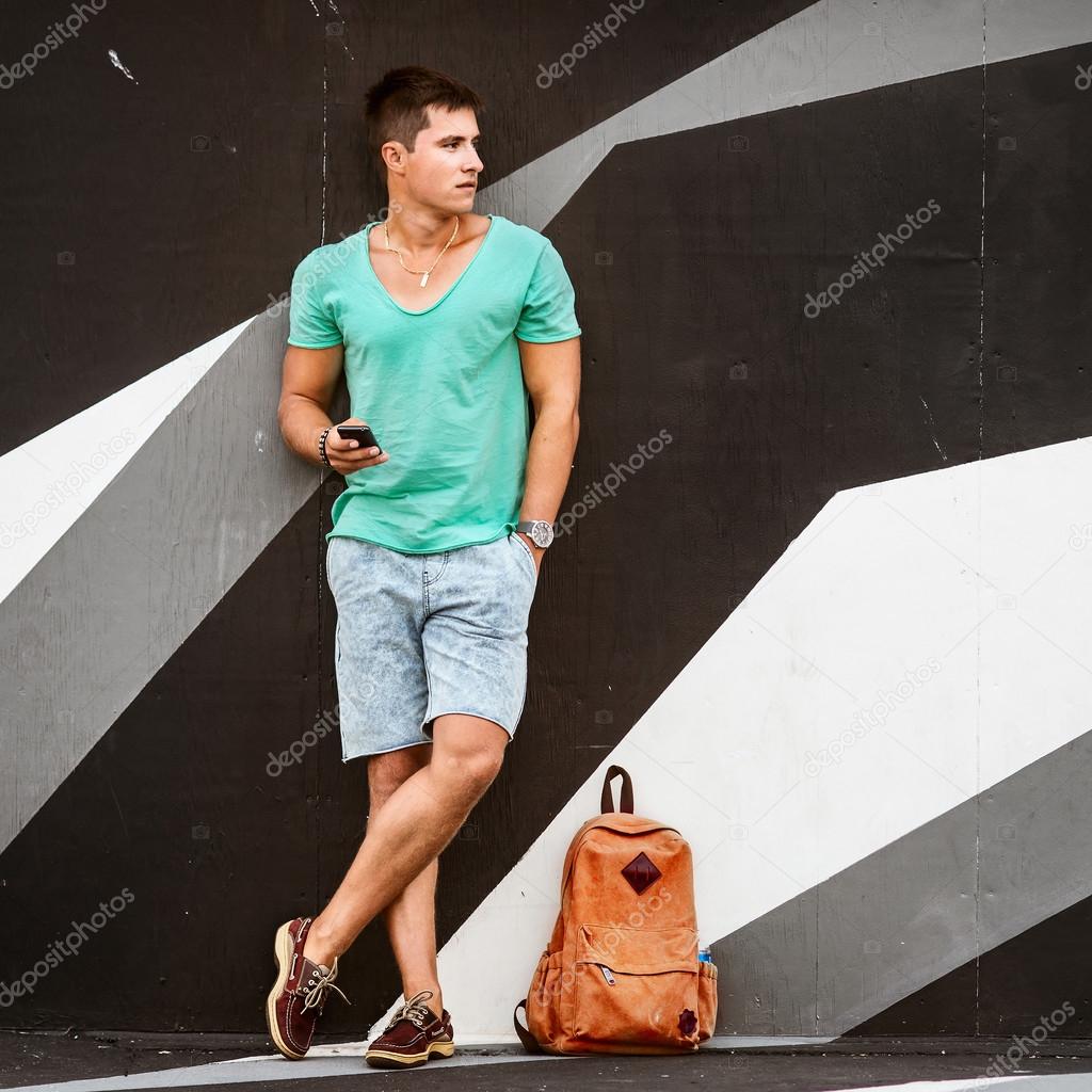 Stylish fashion man traveling with a bag