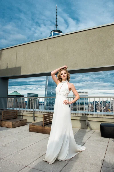 Hermosa novia modelo de moda en vestido de novia blanco de pie en la azotea —  Fotos de Stock