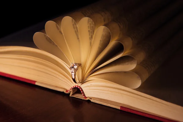 Wedding ring with diamond on the book pages