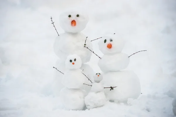 Funny snowman family on the snow — Stock Photo, Image