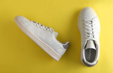 Jeddah Suudi Arabistan 26 Aralık 2020: Beyaz Adidas Koşu botları. Adidas, çok uluslu şirket. Sarı ve turuncu arka planda izole edilmiş. Ürün çekimleri