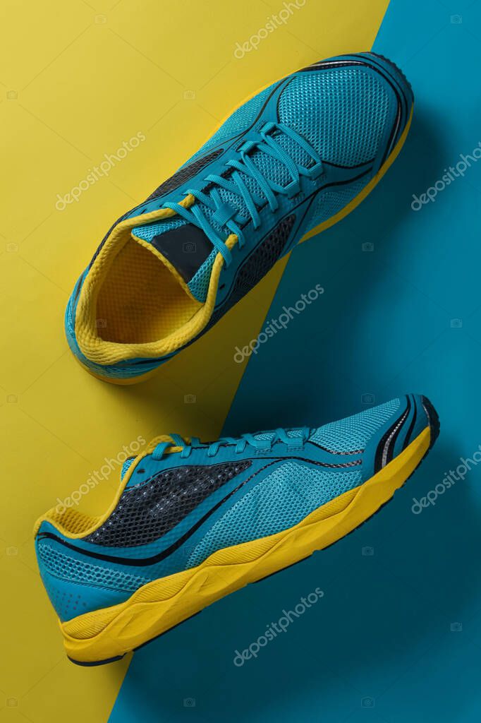 Blue Running boots top view. sport shoes with a Blue and Yellow background with copy space on the right
