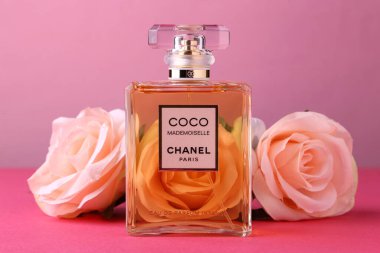 Jeddah Suudi Arabistan 31 Mart 2021 COCO Chanel Floral koku kavramı. Pembe pastel arka planda çiçekli parfüm şişesi Düz yatar ve üst görünümü kopyala.