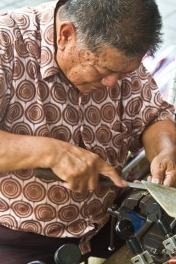 Bangkok sokaklarında çalışan bir adam.