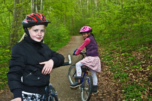 Girls riding on bikes — Stock Photo, Image