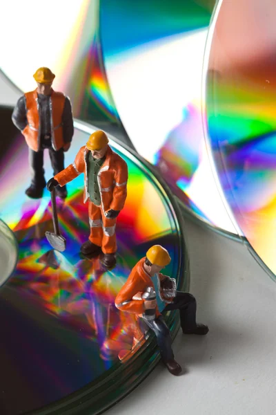 Miniature workers  with CDs — Stock Photo, Image