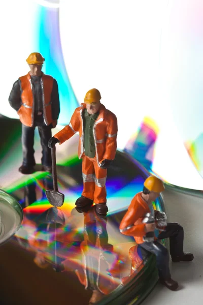 Miniature workers  with CDs — Stock Photo, Image