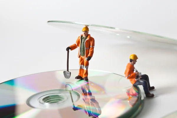 Miniature workers  with CDs — Stock Photo, Image