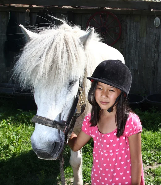 Girl ridding a white horse — Stock Photo, Image