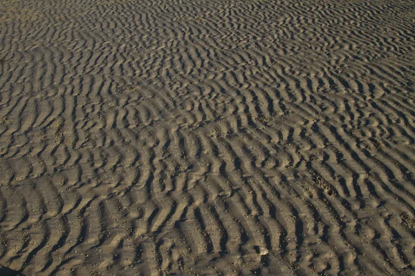 Zand patroon op het strand — Stockfoto