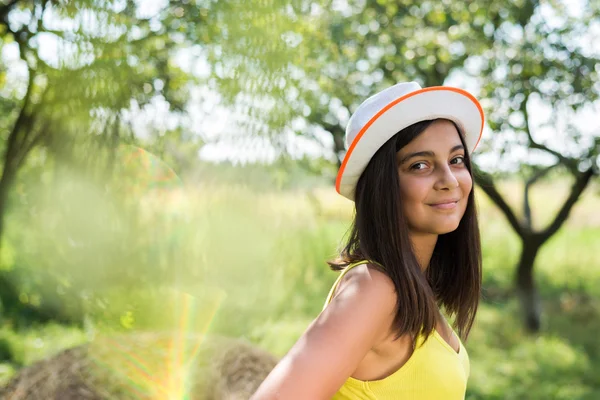 Young pretty teenage girl having fun on green summer outdoors — Zdjęcie stockowe