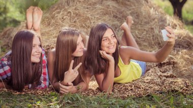 Üç mutlu genç kız selfie telefonla yapıyor