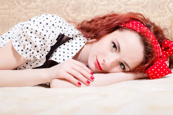 Picture of sensual red haired young woman beautiful pinup girl having fun relaxing lying in bed smiling & looking at camera closeup portrait — Stock Photo, Image