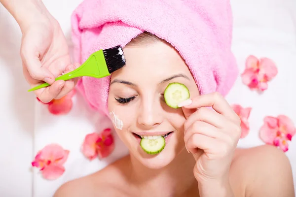 Spa fun: closeup image of funny girl beautiful blond young woman having multi treatment procedures happy smiling eyes closed on white background — Stock Photo, Image