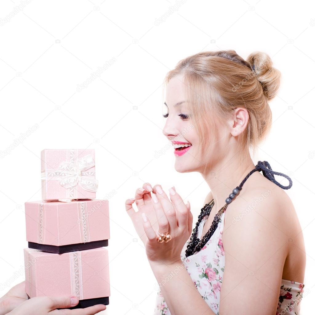 Picture of receiving gifts or presents surprised attractive blond young woman elegant female having fun happy smiling isolated on white background portrait