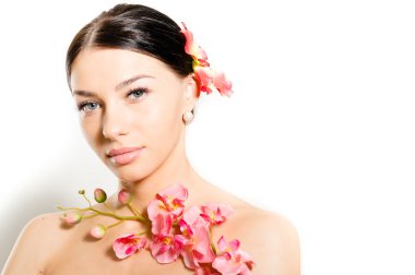 onun kafasını & beyaz kopyalama alanı arka plan üzerinde izole kamera bakıyor elinde tutan pembe orkide orkide çiçeği ile güzel bir genç kadın çıplak omuzlarına esmer seksi spa kız portresi yukarıya kapatmak