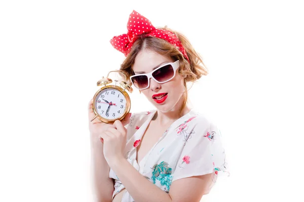 Agitated funny young blond pinup woman with alarm-clock with glasses looking at camera — Stock Photo, Image