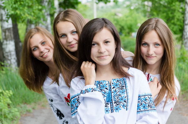 Four girls standing together in park