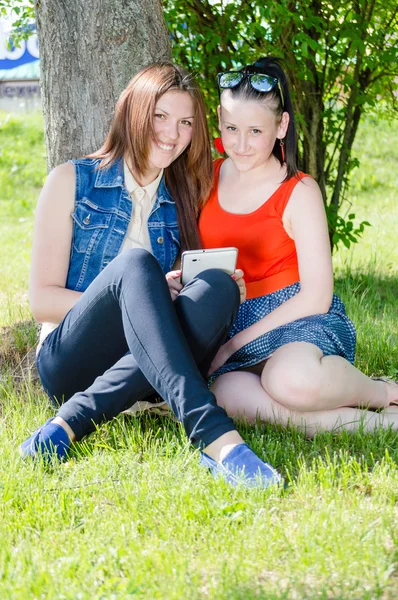 Girls using the internet on white tablet pc computer — Stock Photo, Image