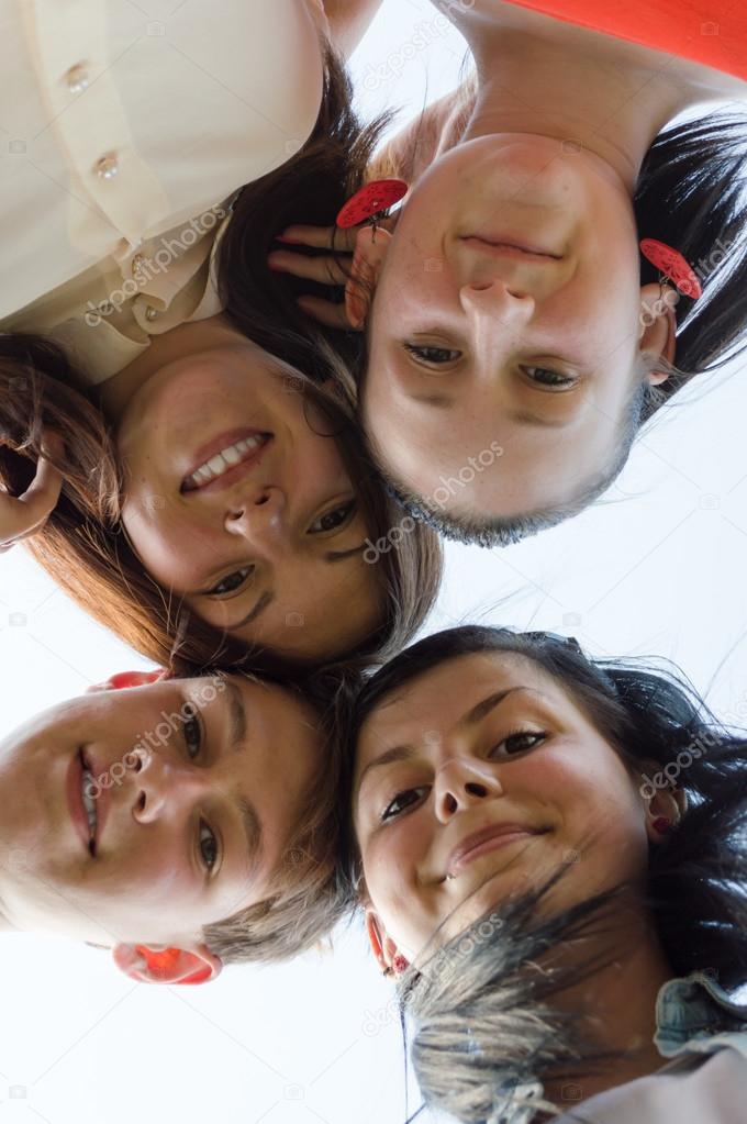 Group of young people standing in a circle