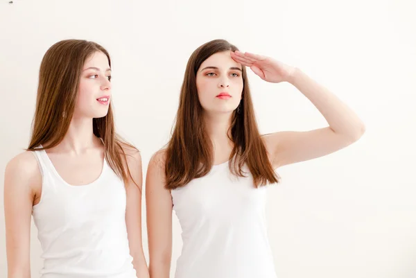 Cute girls happy smiling saluting in white shirts — Stock Photo, Image