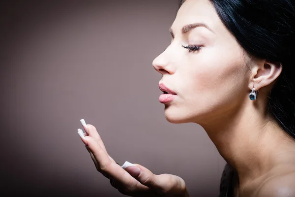 Cleopatra showing copyspace: closeup portrait of beautiful brunette young woman having fun blowing kiss or presenting copy space background picture — Stock Photo, Image