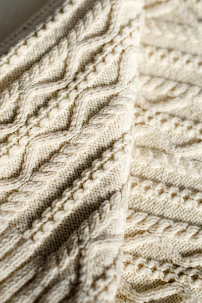 Closeup detail of woven handicraft knit woolen design texture and knitting needle. Fabric white copy space background — Stock Photo, Image