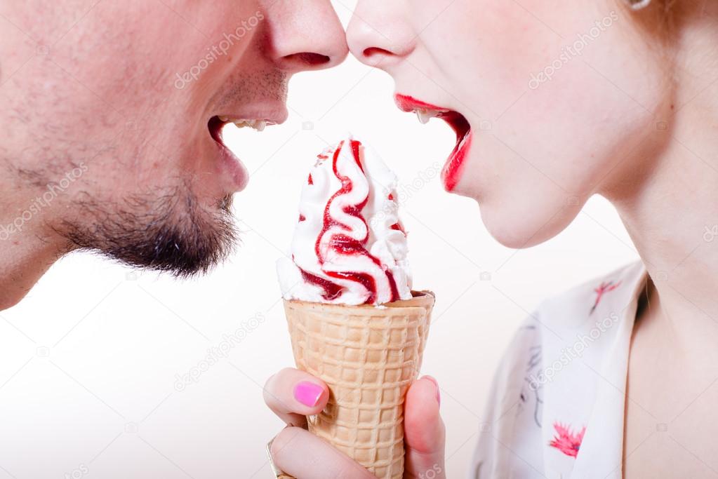 Couple eating one ice-cream cone