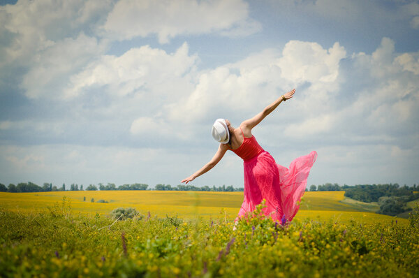 Woman dancing on summer meadow