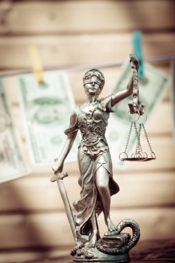 Themis goddess or lady justice holding scale blindfold & USD dollar bank notes hanging on the copy space background showing money laundering concept clipart