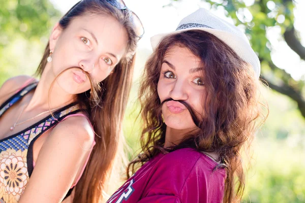 Mulheres brincando com o cabelo como bigode — Fotografia de Stock