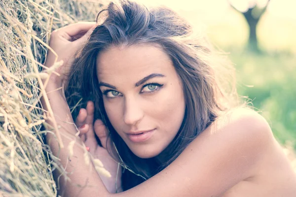 Young woman relaxing on hay — Stock Photo, Image