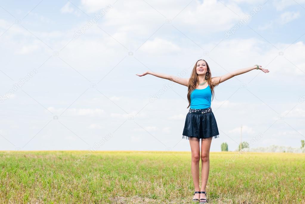 sexy pretty girl in mini skirt jumping high and happy smiling on blue sky outdoors copy space background portrait