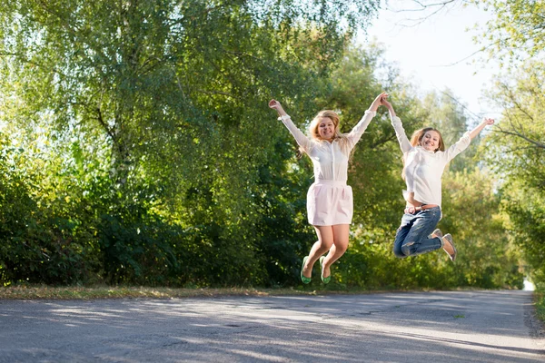 Two girls jumping — Stock Photo, Image