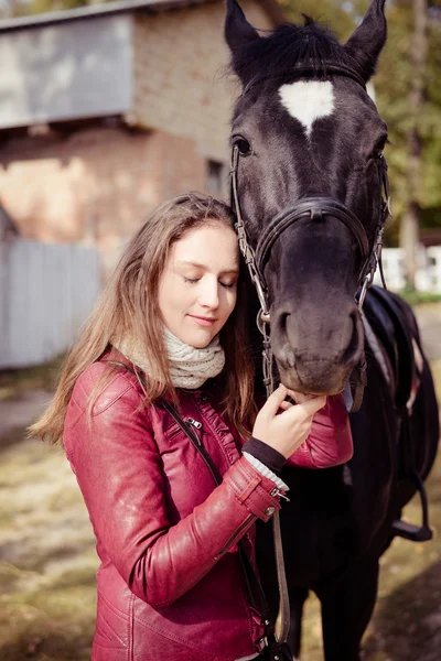 Young woman embracing horse — Stock Photo, Image