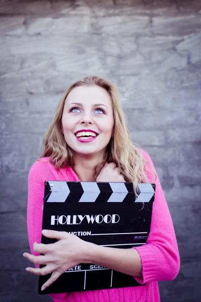 Woman holding cinema clapper board — Stock Photo, Image