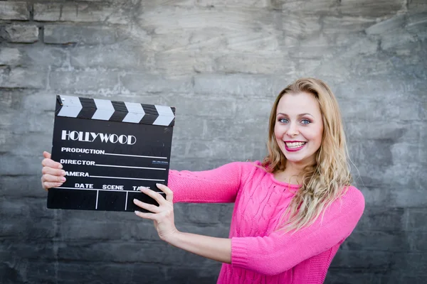 Woman holding clapper board — Stock Photo, Image