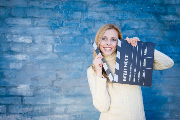 Woman with cinema clapper board