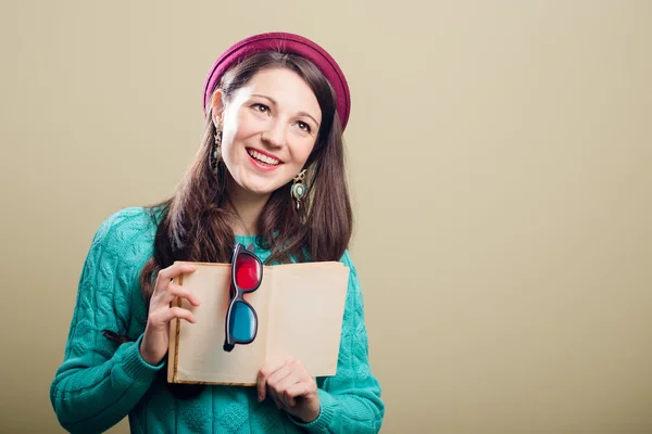 Girl holding a book and 3d glasses — Stock Photo, Image