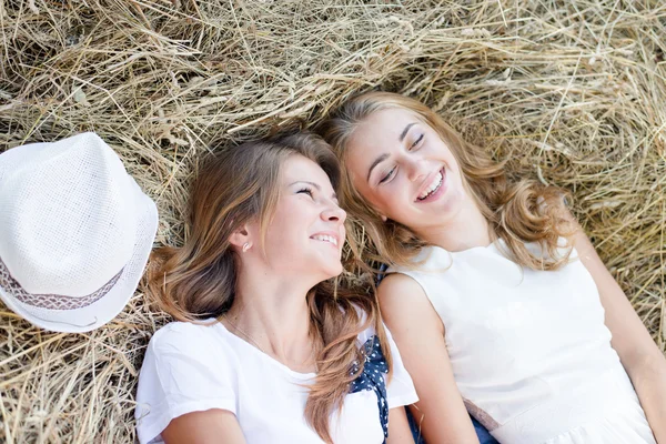 Women lying on hay — Stock Photo, Image