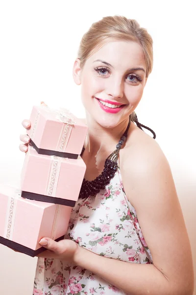 Woman holding  gifts in pink boxes — Stock Photo, Image