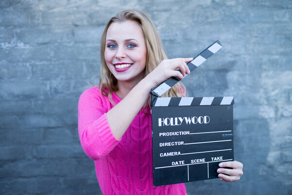 Woman with cinema clapper board