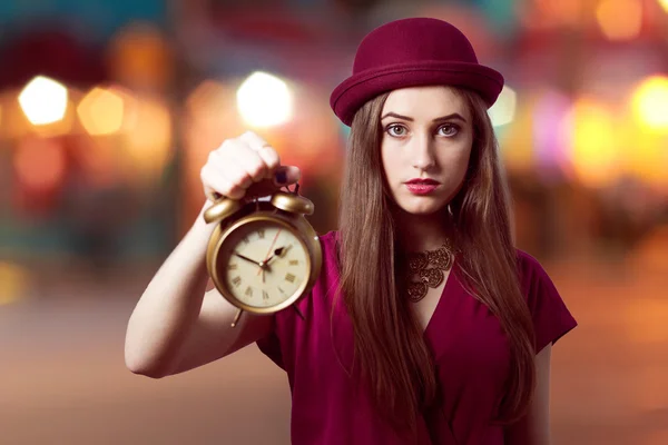 Woman showing alarm clock — Stock Photo, Image