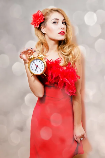 Woman in red dress with alarm clock — Stock Photo, Image