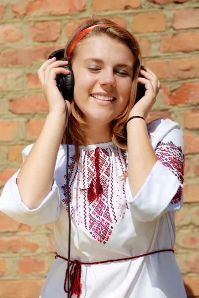 Happy teenage girl in traditional ukrainian blouse singing — Stock Photo, Image