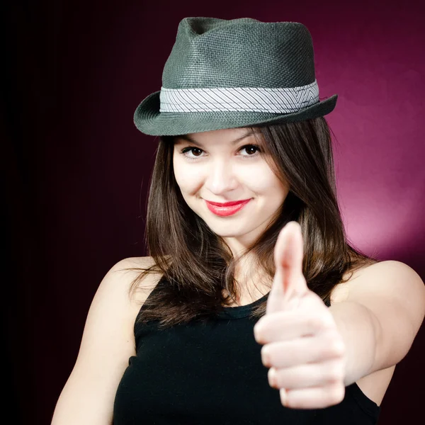 Woman in hat showing thumb — Stock Photo, Image