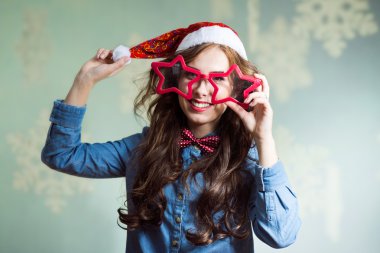 Happy smiling funny hipster girl in santa hat