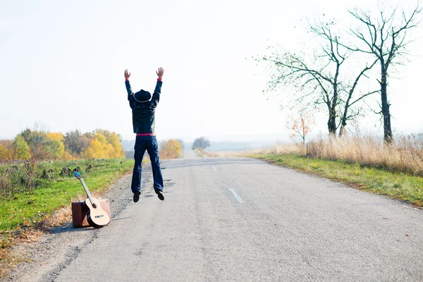 Einsamer Mann mit Retro-Koffer und Gitarre — Stockfoto