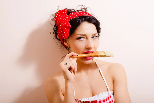 Amazing lady biting paintbrush — Stock Photo, Image