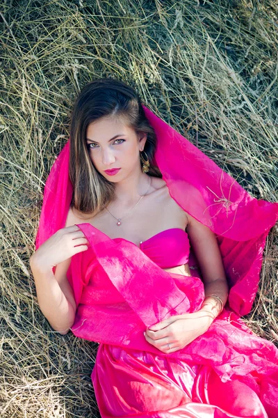 Sexi amazing young lady with long hair in pink — Stock Photo, Image